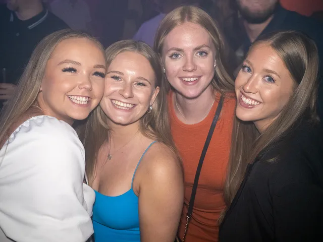 A small group of guests posing together at a celebration