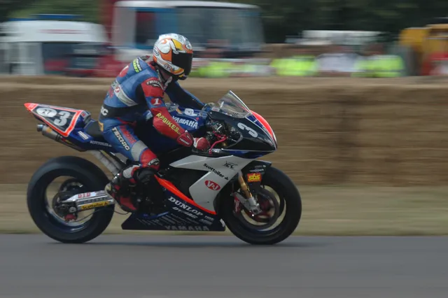 A motorcycle racer leaning into a bend