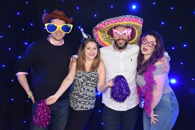 Guests wearing colourful hats at a celebration
